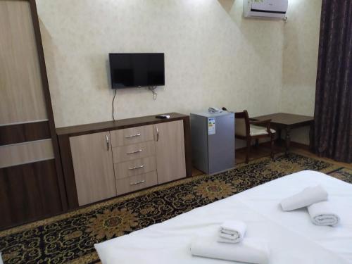 a hotel room with two beds and a television at Bahri Tojik Resort & Spa in Kairakum