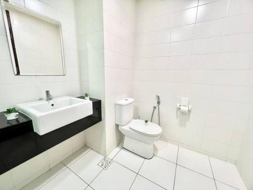 a white bathroom with a sink and a toilet at C 1-5 Pax Cozy home Studio 3Bed WIFI&TV Trefoil Setia Alam SCCC in Setia Alam