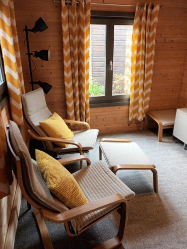 a room with two chairs and a window at Nancy's Cabin in Mosborough