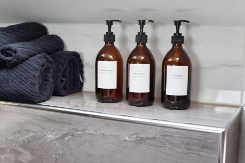 a group of three bottles sitting on a shelf at The Attic in Zagreb