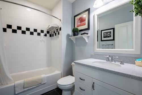 a bathroom with a sink and a toilet and a mirror at Harbour House at the Inn 315 in Fort Myers Beach