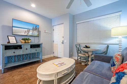 a living room with a couch and a table at Harbour House at the Inn 315 in Fort Myers Beach