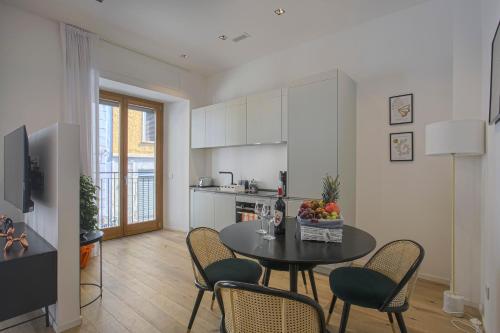 a kitchen and dining room with a table and chairs at MILAN CHIC Luxury Apartments-hosted by Sweetstay in Milan