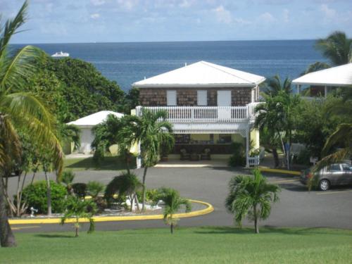 a large house with the ocean in the background at Tamarind Reef Resort Spa & Marina in Christiansted