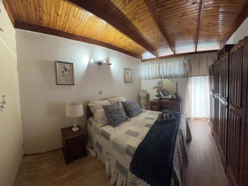 a bedroom with a bed and a wooden ceiling at Six Second Avenue in Parys