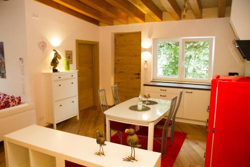 a kitchen with a white table and a red refrigerator at Apartment White der Sportschule Badura in Leipzig