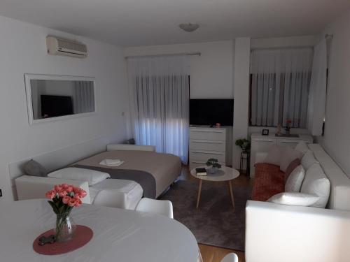 a hotel room with a bed and a living room at Marys Home Apartment Međugorje in Međugorje