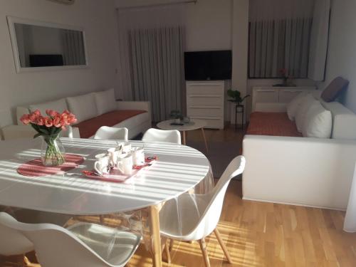 a living room with a white table and white chairs at Marys Home Apartment Međugorje in Međugorje