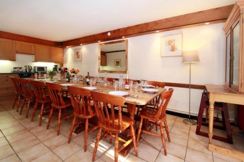 a large dining room with a long table and chairs at Chalet Ruby in Les Deux Alpes