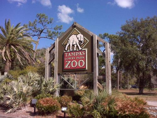 a sign for a zoo with a elephant on it at Green house in Tampa
