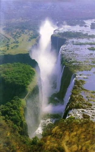 an aerial view of a waterfall in a river at BJ&T Vacation Homes in Kasane
