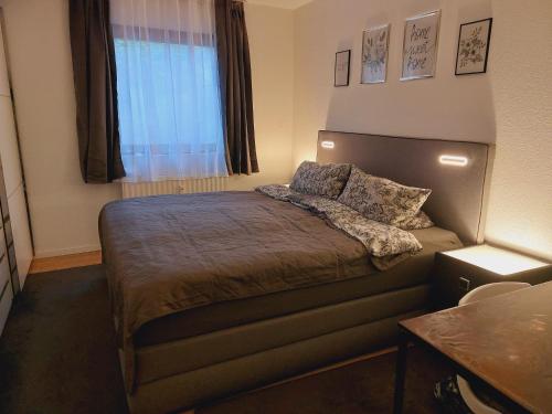 a small bedroom with a bed with a window at Apartement König in Lauf