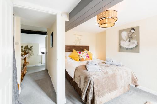 a bedroom with a bed in a room at Why Not in Stow on the Wold