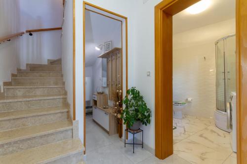 a hallway of a house with stairs and a plant at Magic holiday Apartment in Bale