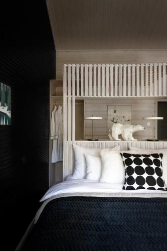 a bedroom with a bunk bed with white pillows at Foxfires Private Boutique Guesthouse in Levi