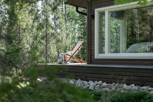 a chair sitting on the porch of a house at Foxfires Private Boutique Guesthouse in Levi