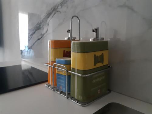 a rack of books on a counter with a sink at Sweet Home Canavese in Castellamonte