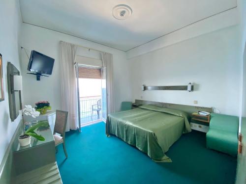 Postel nebo postele na pokoji v ubytování Hotel Kennedy