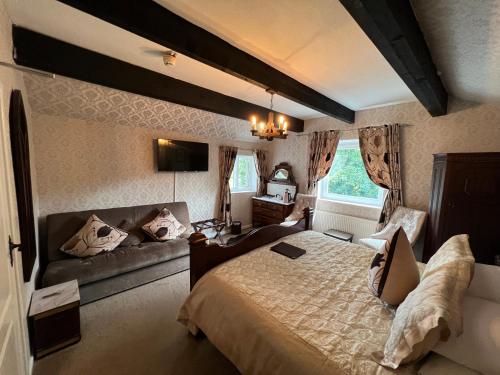 a bedroom with a large bed and a couch at The Courthouse in Betws-y-coed