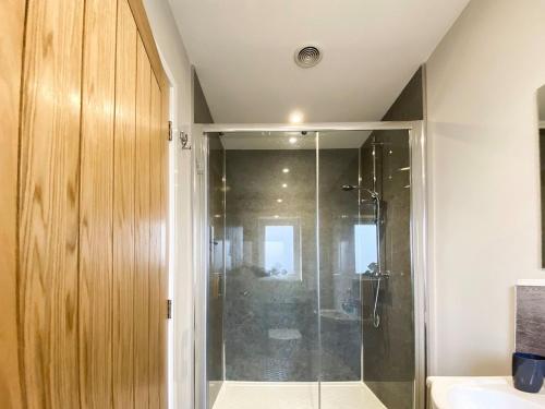 a bathroom with a shower with a glass door at Park View in Martham