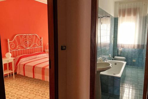 a bedroom with a bed and a sink and a tub at Casa vacanze IL NIDO - 4 stelle in Milazzo