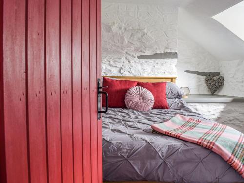 a red door in a bedroom with a bed at Blaen Y Cwm in Carno
