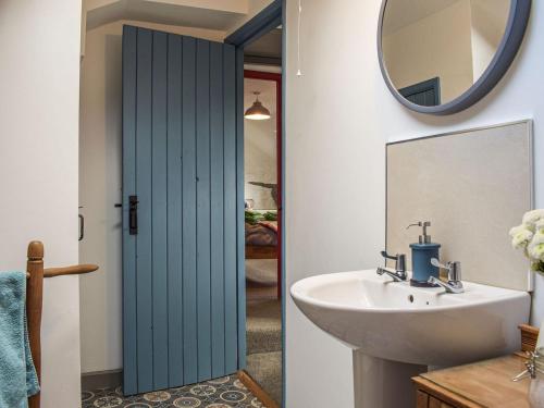 a bathroom with a sink and a mirror at Blaen Y Cwm in Carno