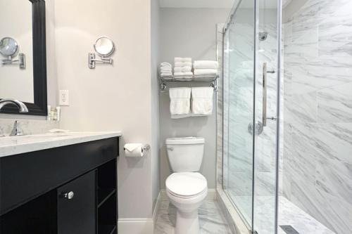 a bathroom with a toilet and a glass shower at Newbury Guest House in Boston