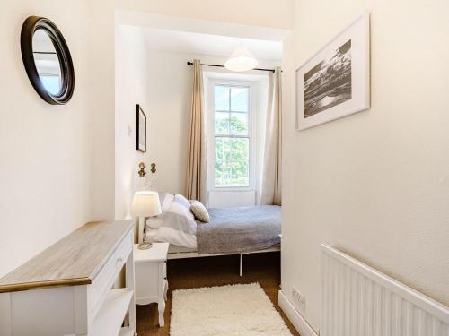 a small bedroom with a bed and a window at The Parade in Berwick-Upon-Tweed