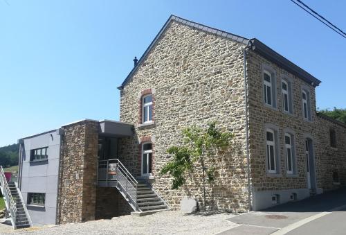 a brick building with stairs on the side of it at Gite Kooa Prestige in Theux