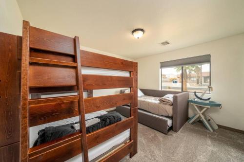 a bedroom with two bunk beds and a couch at Heated Pool & Spa - Winterhavens Oasis in Lake Havasu City