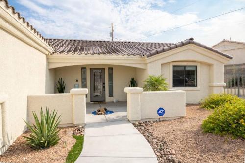 a house with a dog laying in front of it at Heated Pool & Spa - Winterhavens Oasis in Lake Havasu City