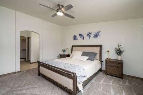 a bedroom with a bed and a ceiling fan at Heated Pool & Spa - Winterhavens Oasis in Lake Havasu City