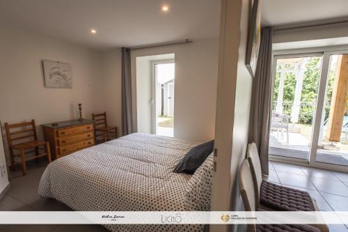 a bedroom with a bed and a sliding glass door at Maison Planté a1 in Argelès-Gazost