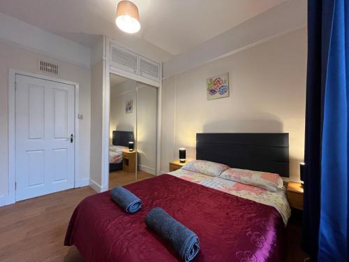 a bedroom with a bed with two pillows on it at Elgin apartment in Elgin