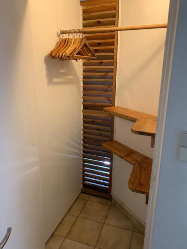 a walk in closet with wooden shelves and a window at Les Manguiers in Deshaies