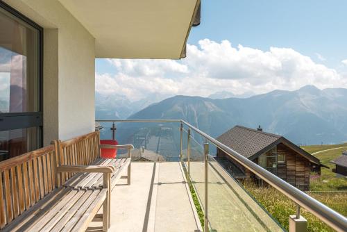 a balcony with a bench and a view of mountains at Bella Vista in Fieschertal