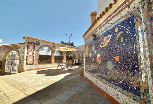 a mosaic wall on a building with a patio at Casa Cueva Los Mosaicos in Guadix