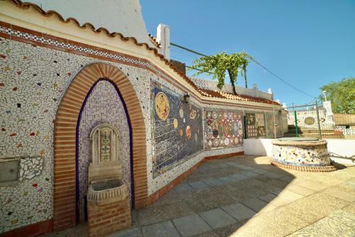 a building with mosaics on the side of it at Casa Cueva Los Mosaicos in Guadix