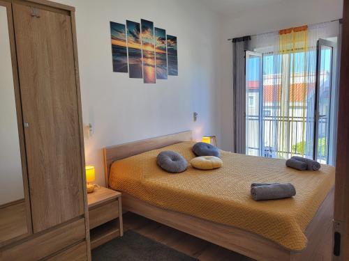 a bedroom with a bed with two pillows on it at Apartman Anabella in Rovanjska