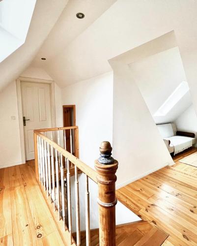 a room with a staircase and a couch at Historisches Amtshaus: BelVue in Fehmarn