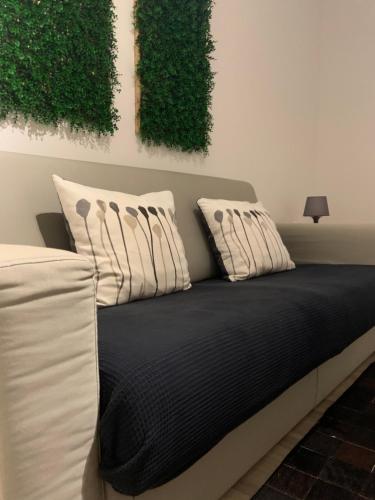 a white bed with white pillows and pillows at Apartments La Casa di Loreto in Rovinj