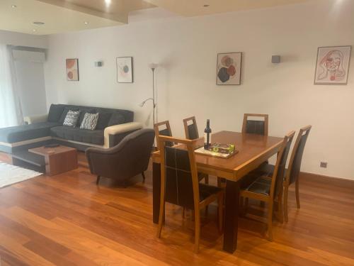 a living room with a table and a couch at Luis Place Machico LifeStyle in Machico