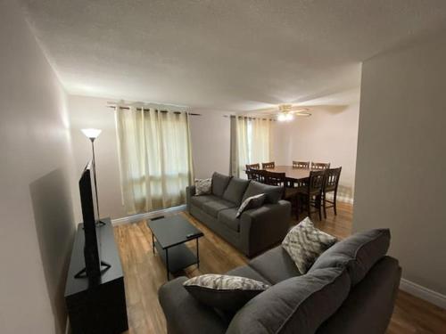 a living room with a couch and a table at AleHar House in Kingston