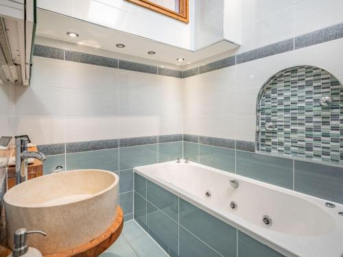 ein Badezimmer mit einer Badewanne und einem Waschbecken in der Unterkunft Kingfisher Cottage in Barkston