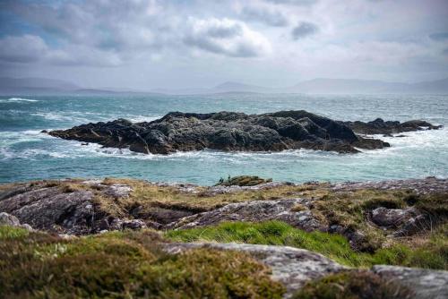 a group of rocks in the ocean near the water at The Rose Suite Kenmare in Kenmare