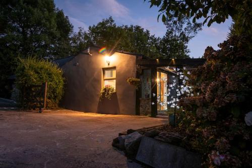 a house with a light on the side of it at The Rose Suite Kenmare in Kenmare