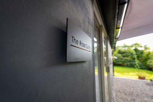a sign that reads the press on a wall at The Rose Suite Kenmare in Kenmare