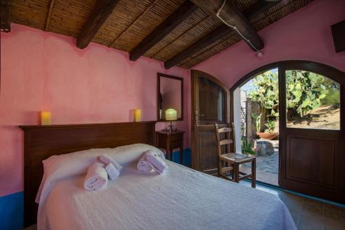 a bedroom with a bed with towels on it at Castello Malicas in Galtellì