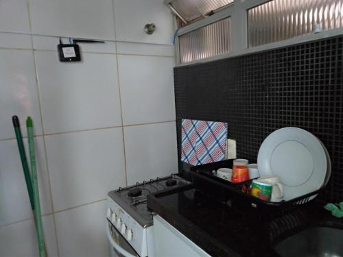 a small kitchen with a stove and a sink at Melhor localização Recife até 6 pessoas in Recife